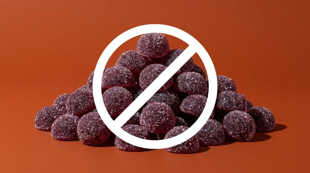 A Pile of cbd + thc gummies with a ban symbol over it